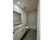 This bathroom is equipped with white cabinets, granite countertops, and a shower at 131 Reena Dr, Daytona Beach, FL 32117
