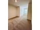This bedroom features neutral carpet, a window, and overhead lighting at 131 Reena Dr, Daytona Beach, FL 32117