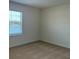 This bedroom features neutral carpet and a window overlooking the yard at 131 Reena Dr, Daytona Beach, FL 32117
