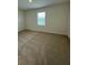This bedroom features neutral carpet and a window at 131 Reena Dr, Daytona Beach, FL 32117