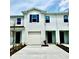 Modern townhome features a one-car garage and minimalist landscaping in the front yard at 131 Reena Dr, Daytona Beach, FL 32117