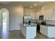 Bright kitchen with white cabinets, stainless steel appliances, and granite countertops on a large island at 131 Reena Dr, Daytona Beach, FL 32117