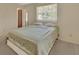 Bright bedroom featuring a large window, neutral decor, and comfortable bed at 1320 Bakersfield Ave, Deltona, FL 32725