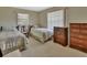 Bedroom featuring two beds, natural light, and wooden furniture at 1320 Bakersfield Ave, Deltona, FL 32725