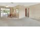 Cozy dining area featuring a glass table, rattan chairs, and sliding glass doors to the porch at 1320 Bakersfield Ave, Deltona, FL 32725