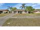 Inviting single-story residence featuring a well-kept front yard and mature palm trees for a tropical feel at 1320 Bakersfield Ave, Deltona, FL 32725