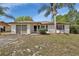 Charming single-story home with a well-maintained lawn and mature palm trees at 1320 Bakersfield Ave, Deltona, FL 32725