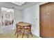 Small eat-in kitchen features a table and view into the dining area at 1320 Bakersfield Ave, Deltona, FL 32725