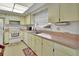 Well-lit kitchen with light-colored cabinetry, essential appliances, and ample counter space at 1320 Bakersfield Ave, Deltona, FL 32725