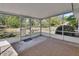 Enclosed back porch with screen and textured tan rug at 1320 Bakersfield Ave, Deltona, FL 32725