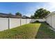 Back yard with green grass and white vinyl fence at 1340 Babcock Ave, Deltona, FL 32725