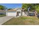 Charming single-story home featuring a well-maintained lawn and a two-car garage at 1340 Babcock Ave, Deltona, FL 32725