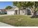 Inviting home with a neatly landscaped lawn, white garage door, and charming front porch at 1340 Babcock Ave, Deltona, FL 32725