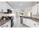 Contemporary kitchen featuring white cabinets, stainless steel appliances, and a functional layout at 1340 Babcock Ave, Deltona, FL 32725