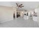 Open-concept living room and kitchen with tile flooring, modern lighting, and ceiling fan at 1340 Babcock Ave, Deltona, FL 32725