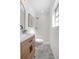 Modern bathroom featuring a glass shower, updated vanity, and stylish gray geometric floor tiles at 140 E Faith Ter, Maitland, FL 32751