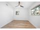 Airy bedroom with wood-look floors, large windows, and a ceiling fan for a light and bright feel at 140 E Faith Ter, Maitland, FL 32751