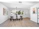 Bright dining area with wood floors, stylish lighting, and a view of the front yard at 140 E Faith Ter, Maitland, FL 32751