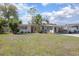 Beautiful home showcasing a meticulously maintained lawn, with mature landscaping and a convenient carport at 140 E Faith Ter, Maitland, FL 32751