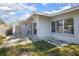 Exterior view of patio with tiled floor and modern white brick walls, complemented by a partial privacy fence at 140 E Faith Ter, Maitland, FL 32751