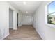 Bright hallway with new floors, white walls, and access to the outside at 140 E Faith Ter, Maitland, FL 32751