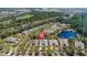 Aerial view of home in established neighborhood with pond and tree-lined streets at 1422 Carlow Cir, Ormond Beach, FL 32174