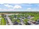 Aerial view of a shopping center with ample parking, trees, and landscaping on a sunny day at 1422 Carlow Cir, Ormond Beach, FL 32174