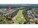 Stunning aerial view of property overlooking the lush green golf course with beautiful homes and mature trees at 1422 Carlow Cir, Ormond Beach, FL 32174