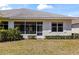 View of the home's backyard, showcasing the screened in patio and manicured lawn at 1422 Carlow Cir, Ormond Beach, FL 32174