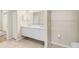 Bathroom featuring double vanity sinks, large mirror, tiled floors, and a doorway into an adjacent room at 1422 Carlow Cir, Ormond Beach, FL 32174