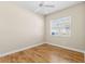 Neutral bedroom with hardwood floors, ceiling fan, and a window offering natural light at 1422 Carlow Cir, Ormond Beach, FL 32174