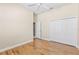 Spacious bedroom with hardwood floors, ceiling fan, and a large closet at 1422 Carlow Cir, Ormond Beach, FL 32174