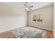 Well-lit bedroom featuring laminate flooring, a ceiling fan, and a large window for ample light at 1422 Carlow Cir, Ormond Beach, FL 32174