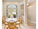 Bright breakfast nook with large window and cozy seating, perfect for casual dining at 1422 Carlow Cir, Ormond Beach, FL 32174