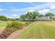 Community clubhouse nestled in lush landscaping with golf course views on a bright day at 1422 Carlow Cir, Ormond Beach, FL 32174