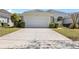 Exterior of a home featuring a two-car garage and a wide driveway at 1422 Carlow Cir, Ormond Beach, FL 32174