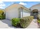 Exterior view of a home with a two-car garage and neatly trimmed hedges at 1422 Carlow Cir, Ormond Beach, FL 32174