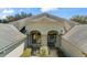 Attractive home exterior with charming architectural details, covered entry and a bench at 1422 Carlow Cir, Ormond Beach, FL 32174