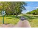Scenic golf course view featuring lush green fairways, mature trees, and a well-maintained path on a sunny day at 1422 Carlow Cir, Ormond Beach, FL 32174