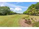 Expansive golf course view with lush greenery, mature trees, and colorful flowerbeds at 1422 Carlow Cir, Ormond Beach, FL 32174