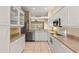 Functional kitchen with white cabinets, stainless steel appliances, and ample countertop space at 1422 Carlow Cir, Ormond Beach, FL 32174