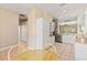 Open kitchen design with white cabinets, tile flooring and breakfast nook at 1422 Carlow Cir, Ormond Beach, FL 32174