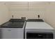 Modern laundry room featuring a Whirlpool washer and dryer and a convenient storage shelf at 1422 Carlow Cir, Ormond Beach, FL 32174