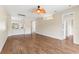 Spacious living area with wood laminate flooring, ceiling fan, and modern lighting fixtures at 1422 Carlow Cir, Ormond Beach, FL 32174