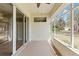 Enclosed patio with sliding glass doors and screens, offering views of the backyard and surrounding trees at 1422 Carlow Cir, Ormond Beach, FL 32174