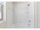 Clean bathroom shower featuring white tiles, a tub, and an adjustable shower head at 1422 Carlow Cir, Ormond Beach, FL 32174