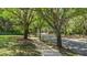 Beautiful street view with sidewalk lined with mossy trees in the Halifax Plantation community at 1422 Carlow Cir, Ormond Beach, FL 32174