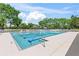 Large community swimming pool with crystal clear water, surrounded by lounge chairs and lush greenery at 1422 Carlow Cir, Ormond Beach, FL 32174