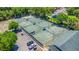 Aerial view of community tennis courts and parking, surrounded by lush trees and greenery for recreation at 1422 Carlow Cir, Ormond Beach, FL 32174