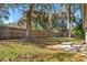 A large backyard featuring a well-maintained wooden fence and tall shade trees at 1430 17Th St, Orange City, FL 32763